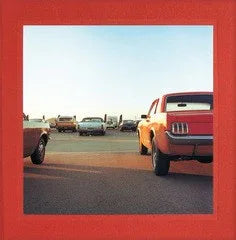 Vintage cars on a road with a red border - William Eggleston 