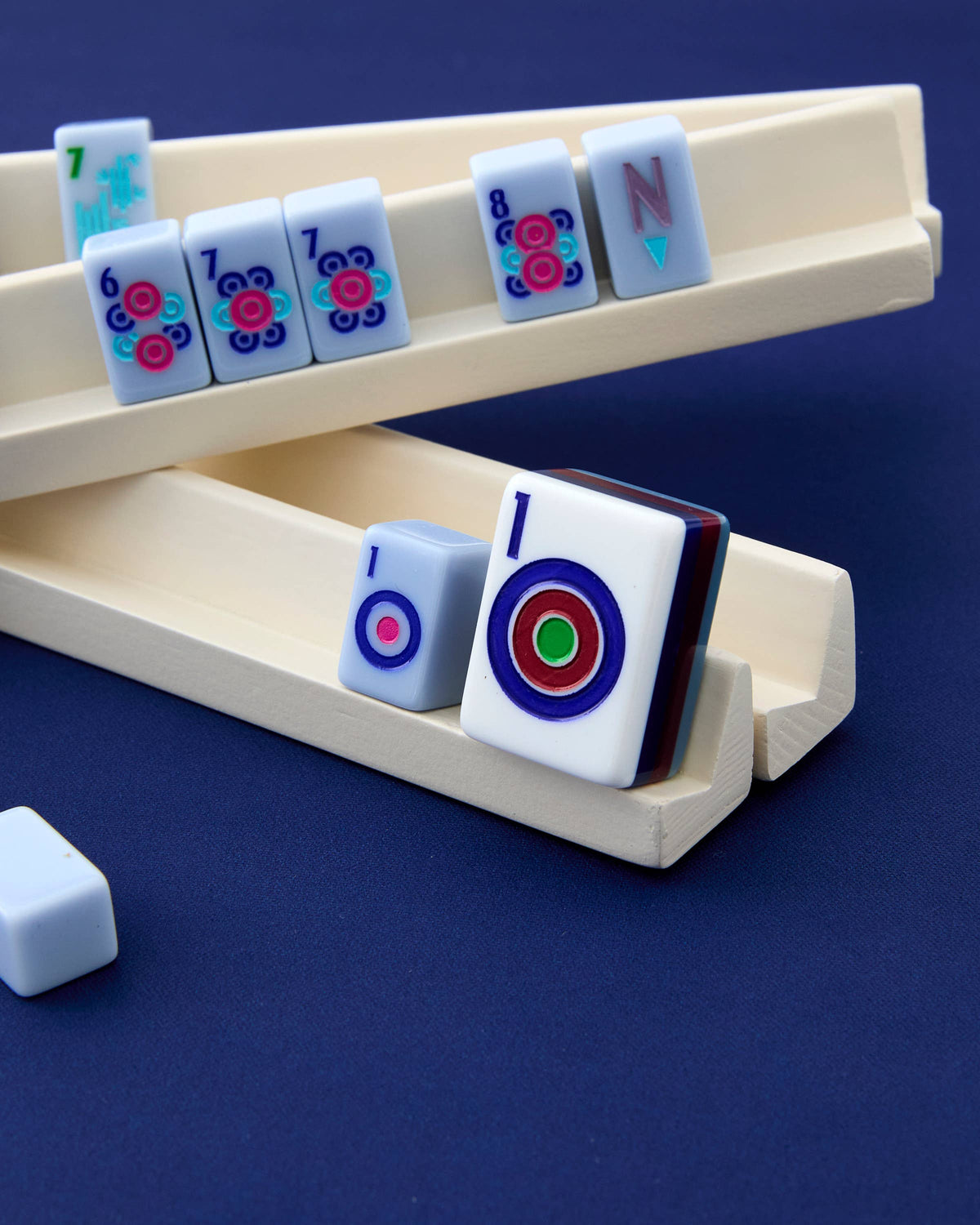 Mahjong tiles with colorful designs on a blue background