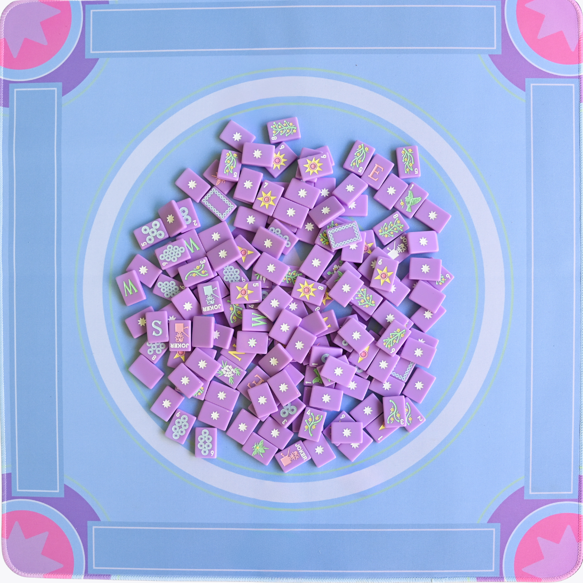 Purple mahjong square tiles with decorative patterns on a blue background