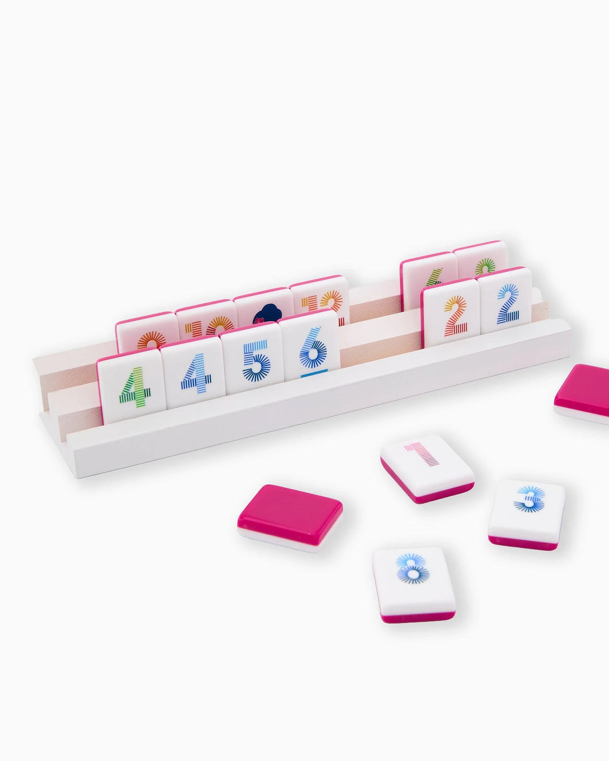 Set of colorful number tiles with a white tray on a white background
