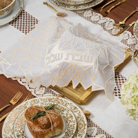 Cream Geometric Challah Cover displayed on a shabbat table. 