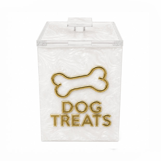 A clear acrylic dog treats container with a textured white interior, featuring a gold metal bone outline and the words 'DOG TREATS' on the front, set against a plain white background.