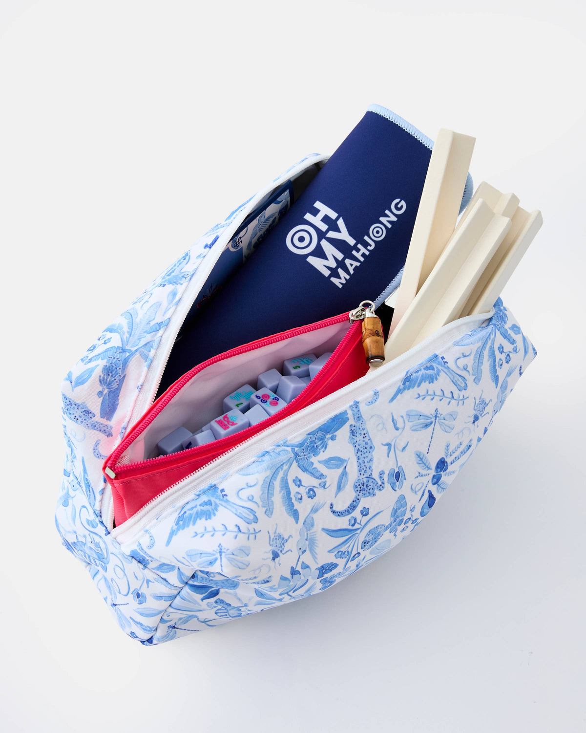 Blue floral-patterned pouch with a mahjong set on a white background