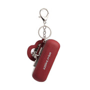 A red textured leather keychain case with a heart-shaped charm and silver metal hardware, featuring the text 'Zombie Twins' on the side, shown against a plain white background.