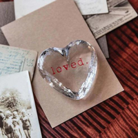 Loved. Crystal glass decorative object with "Loved" written at the center. 