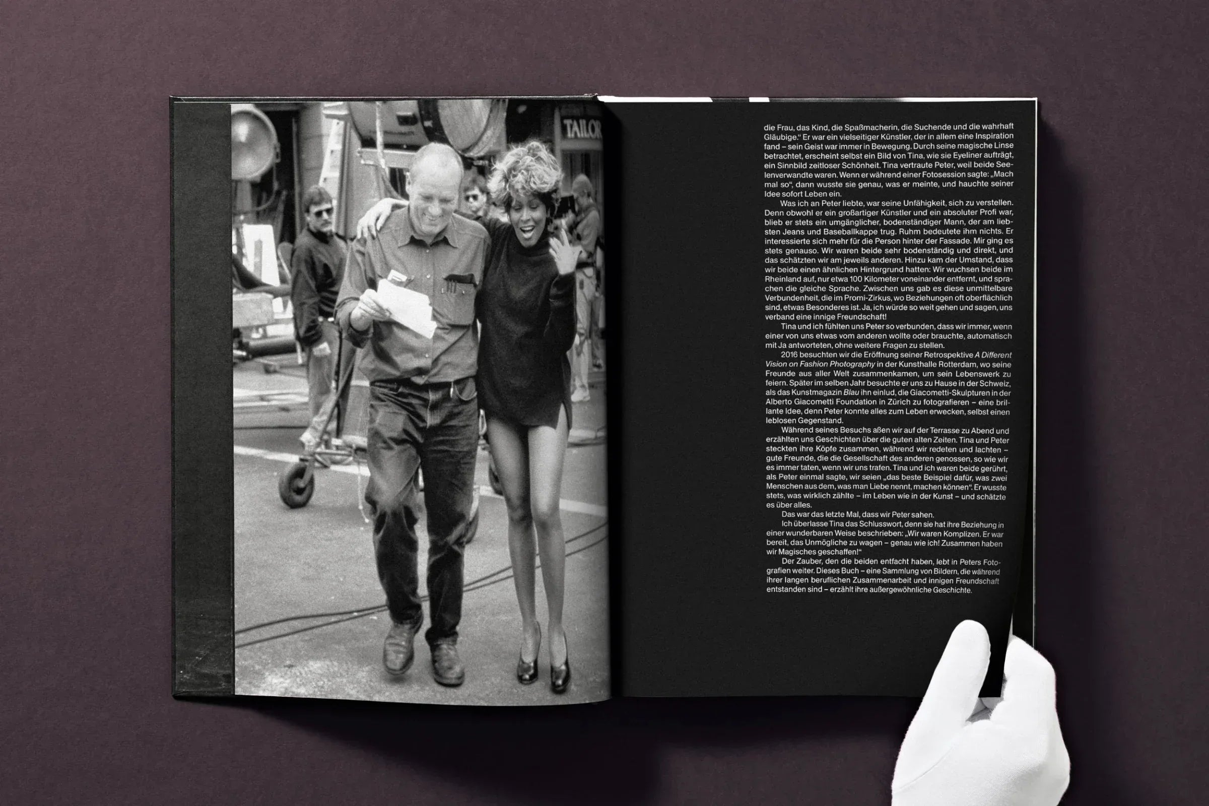 Open book showing a black and white photo of a man and woman walking together, with text on the right page.