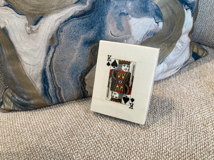 King of Spades playing card on a textured surface