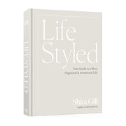 The book 'Life Styled' by Shira Gill, featuring a minimalist off-white cover with elegant white typography and a matching spine, shown on a clean white background.
