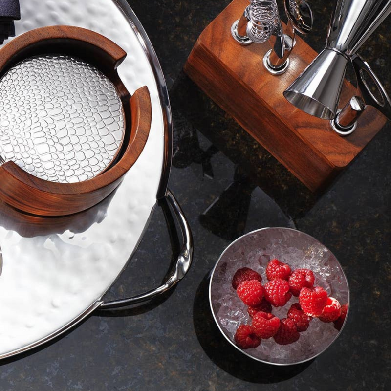 Luna round bowl displayed here with coasters and bar tools. 