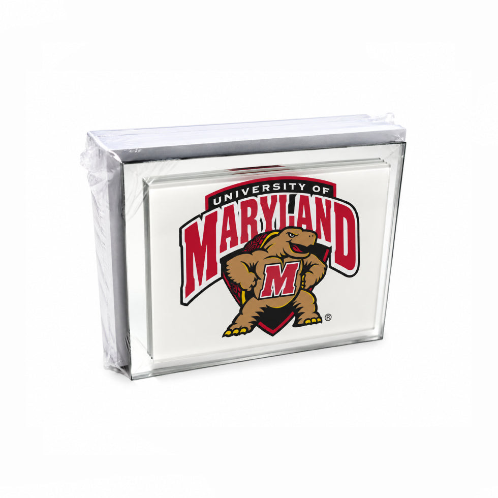 A clear acrylic block sign featuring the University of Maryland Terracotta M logo, wrapped in protective plastic on a white background.