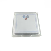 A clear acrylic stand holding a stack of white notepads with a blue border and a small tennis racket illustration near the top.