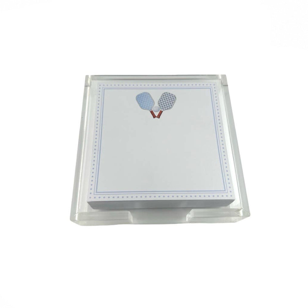 A clear acrylic stand holding a stack of white notepads with a blue border and a small tennis racket illustration near the top.
