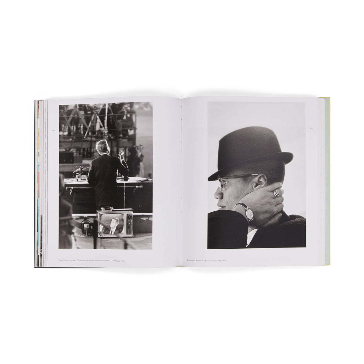 Open book showing black and white photos of a person in a hat and another in a room.
