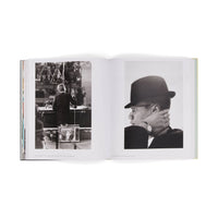 Open book showing black and white photos of a person in a hat and another in a room.