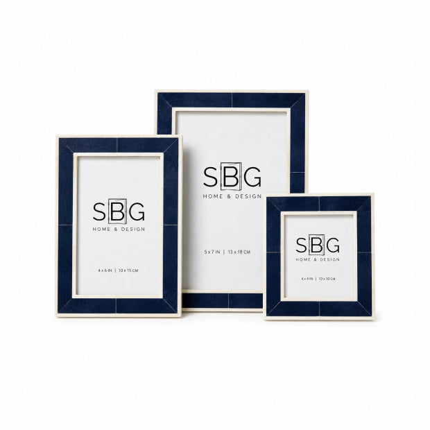 Three picture frames in a coordinated navy and white set, shown on a clean white background. The frames have a geometric tile-like border design in navy blue with white inner sections.