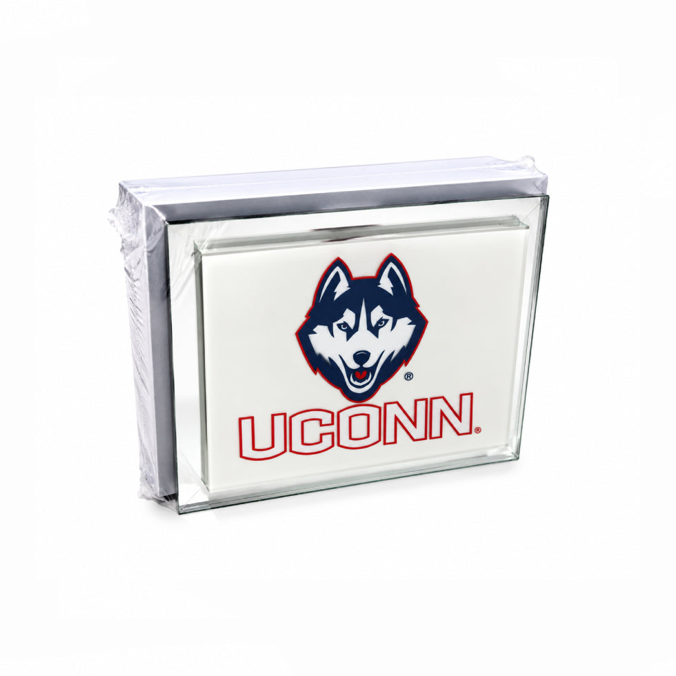 A clear acrylic block sign featuring the UConn Huskies logo and 'UCONN' text on a white background, wrapped in protective plastic.