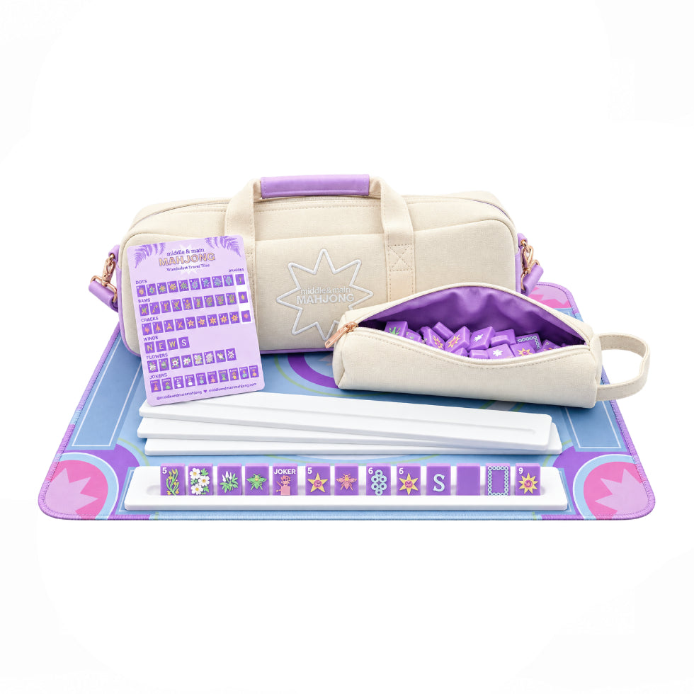 Set of bags and mahjong accessories on a mat with a white background