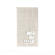 A rectangular beige linen kitchen towel with the words 'WASH. DRY.
